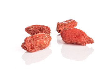 Group of four whole dried red goji isolated on white background