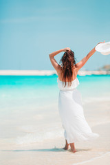 Fototapeta na wymiar Young beautiful woman on white sand tropical beach.