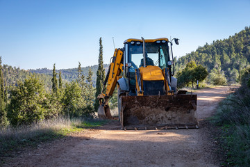 A Backhoe Loader Clearing a Path