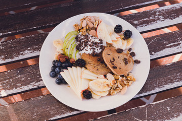Healthy and energetic breakfast closeup with pancakes, fruit, blueberries