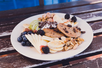 Healthy and energetic breakfast with pancakes, fruit, blueberries and nuts