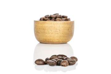 Lot of whole fresh coffee bean in bamboo bowl isolated on white background