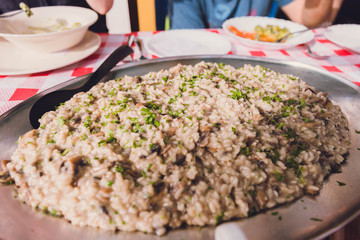 Mushroom and parsley risotto on an Italian table