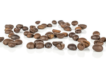 Lot of whole disordered fresh coffee bean isolated on white background