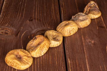 Group of six whole dried fig on brown wood