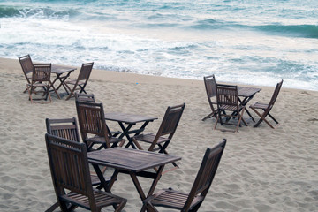 wooden cafe tables by the sea