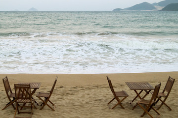 Fototapeta na wymiar wooden cafe tables by the sea