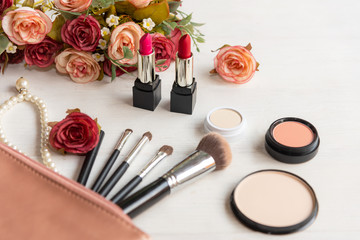Obraz na płótnie Canvas Valentine Gift. Makeup cosmetics tools background and beauty cosmetics, products and facial cosmetics package lipstick, eyeshadow with flower rose, Pearl necklace