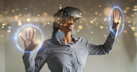 An young woman is using innovative technology vr glasses with augmented reality holograms. Concept...