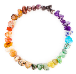 Circle made of colorful semiprecious gemstones isolated on a white background.