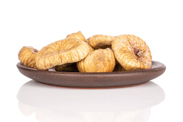 Lot of whole dried fig with brown ceramic coaster isolated on white background