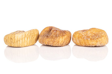 Group of three whole dried fig isolated on white background
