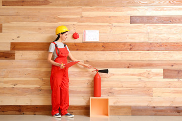 Fire safety specialist inspecting extinguisher