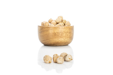 Lot of whole fresh tan chickpea in bamboo bowl isolated on white background