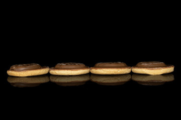 Group of four whole chocolate biscuit line isolated on black glass
