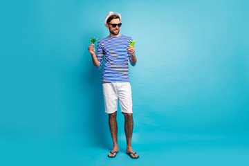 Full body photo of funky traveler guy browsing telephone drink green cocktail all inclusive resort...