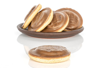 Group of five whole chocolate biscuit with brown ceramic coaster isolated on white background