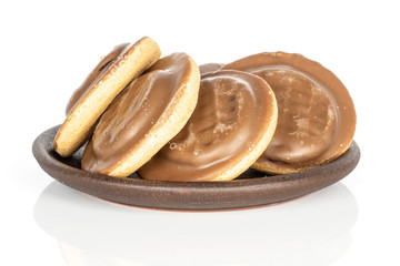 Group of four whole chocolate biscuit with brown ceramic coaster isolated on white background