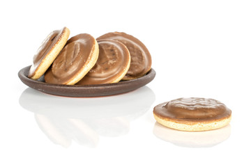 Group of five whole chocolate biscuit with brown ceramic coaster isolated on white background