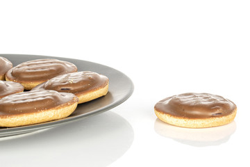 Group of six whole chocolate biscuit on gray ceramic plate isolated on white background