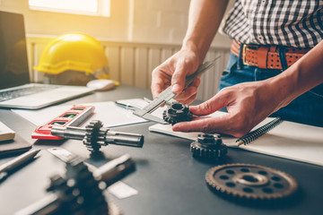 Mechanical engineers are working on the caliper to measure the gear. To design the machine