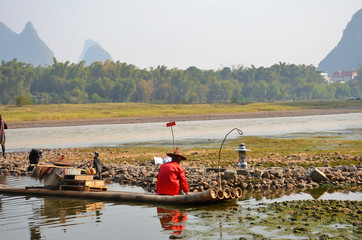 Cormorant Fisherman With His Raft at the Li River in Yangshuo, Guilin, China