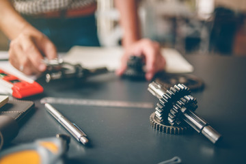 Mechanical engineers are working on the caliper to measure the gear. To design the machine