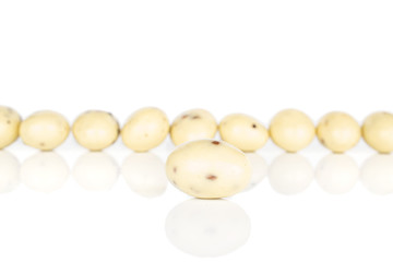 Lot of whole coated white almond nut stracciatella front focus isolated on white background
