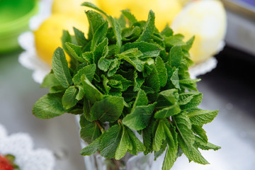 Green fresh mint om the wooden table, selective focus
