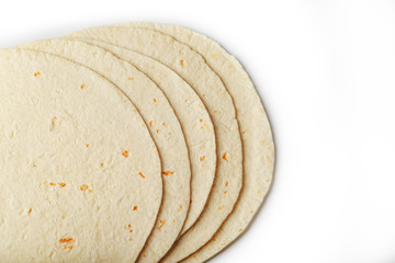 Tortilla on a white isolated background. Corn tortilla or simply tortilla is a type of thin unleavened bread made from Hominy.