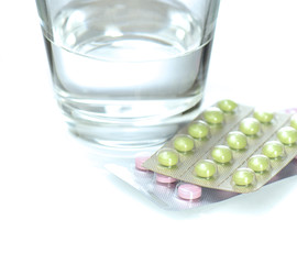 Glass of water and pills. Medicine, tablets, water.