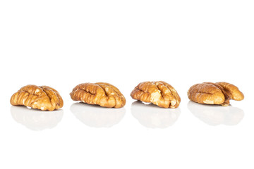 Group of four whole tasty brown pecan half isolated on white background