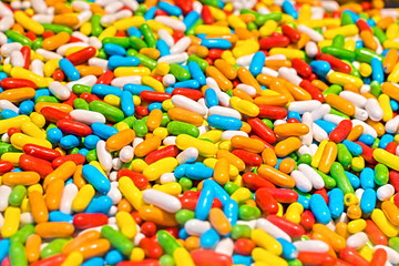 Fototapeta na wymiar A bunch of jelly beans. Dragees and sweet colored candies of all colors of the rainbow.