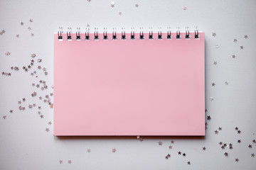Planning concept notebook with festive decorations and place for text on white table. Flat lay style, pastel colours