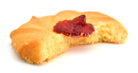 Strawberry biscuit on white reflective background.