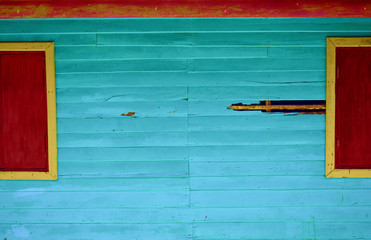 background of the old blue plank has red windows on the side for the design work.