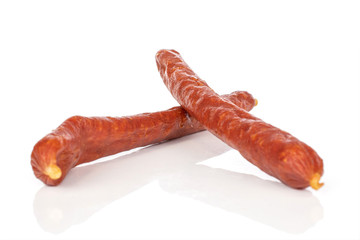Group of two whole piquant smoked sausage isolated on white background