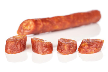 Group of one half four slices of piquant smoked sausage isolated on white background