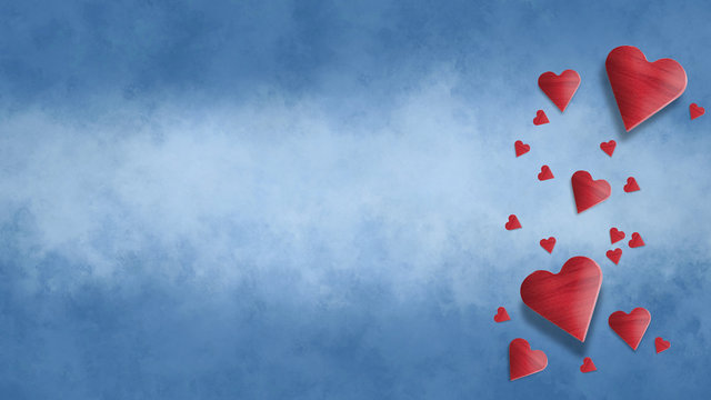 Red wooden Valentine's hearts with blue background with clouds