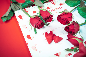 flat lay decorate design for valentine's day with red rose on calendar  background and copy space