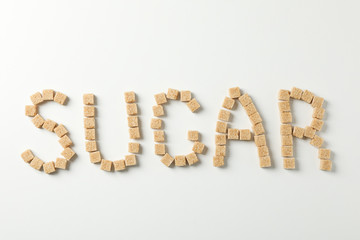 Word Sugar made of sugar cubes on white background, top view