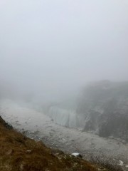 Breathtaking scenery at the Gullfoss Golden Waterfall landmark, a nature attraction in Iceland: Arctic nature with majestic rocks, the Hvita river running in the winter canyon with a cloudy white sky