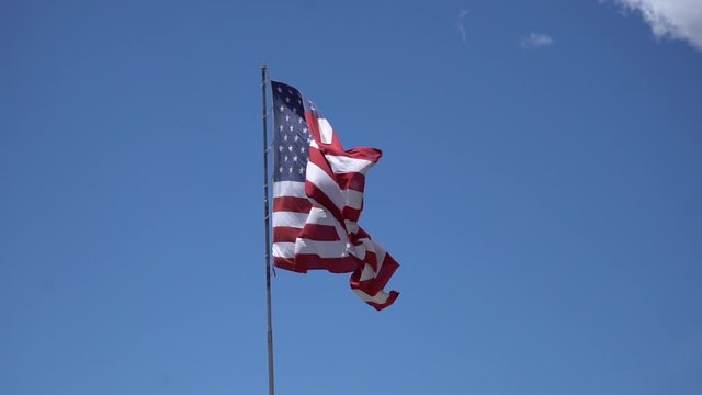 Slow Motion Us American Flag Waving On Blue Sky 