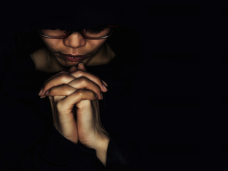 Christian women pray for blessings with faith on a black background.