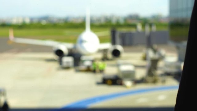 Pensive woman stay against terminal window of International airport. Business lady 