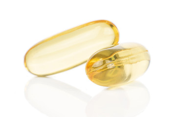 Group of two whole golden fish oil isolated on white background