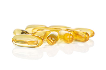 Lot of whole golden fish oil isolated on white background