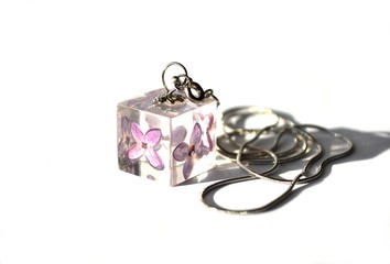 Beautiful epoxy resin jewelry with real dried flowers - lilac. Cube-shaped handmade pendant on a chain.