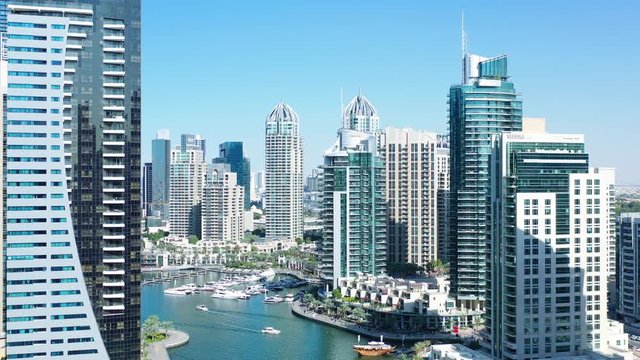 Aerial view of Dubai city. Drone fly over futuristic Dubai Marina district on beautiful day. Residential Modern skyscraper buildings, Jumeirah Beach, UAE, Middle East smart city
