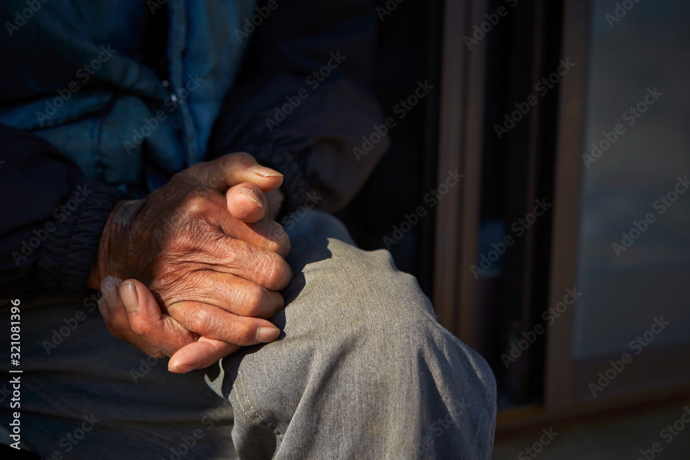 Wall mural old man's hands sitting at porch